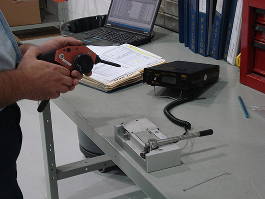 Man calibrating crimp tool. Repair and calibration services by Patlon.